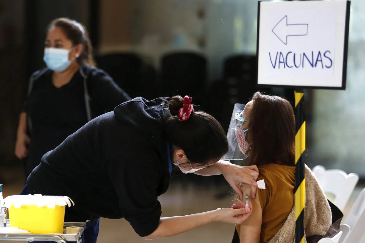A health worker vaccinates a citizen over 60 years old with the Sinovac vaccine on March 19, 2021, in Santiago, Chile. (Marcelo Hernandez/Getty Images)