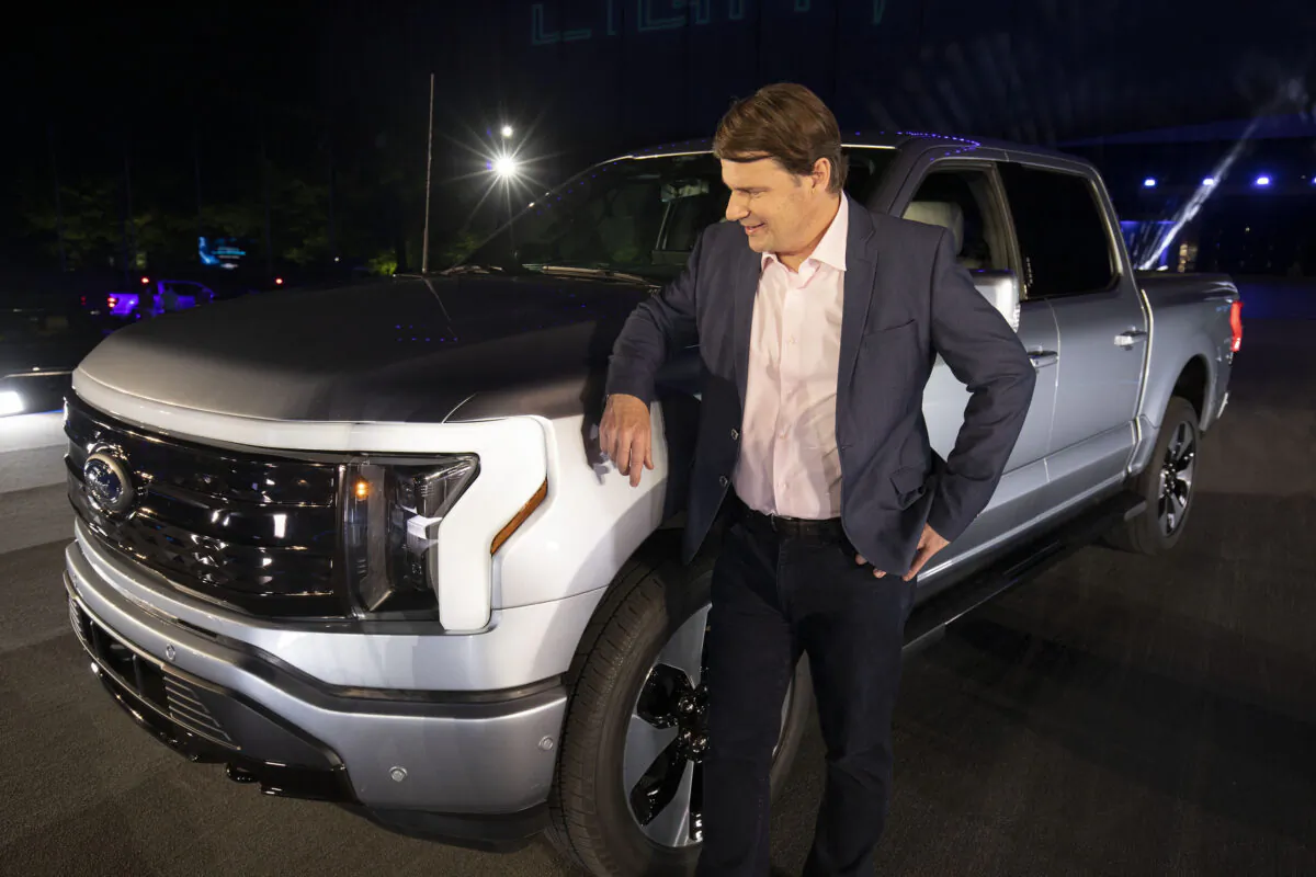 Jim Farley, CEO of Ford Motor Company, poses with the new all-electric F-150 Lightning performance truck at its reveal at Ford World Headquarters in Dearborn, Michigan on May 19, 2021. (Bill Pugliano/Getty Images)