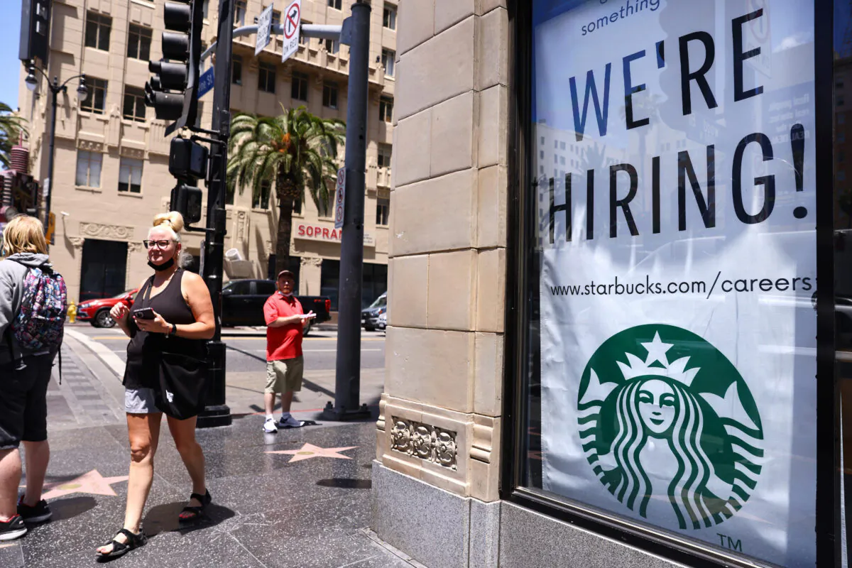 A 'We're Hiring!' sign is displayed at a Starbucks on Hollywood Boulevard in Los Angeles, California, on June 23, 2021. (Mario Tama/Getty Images)