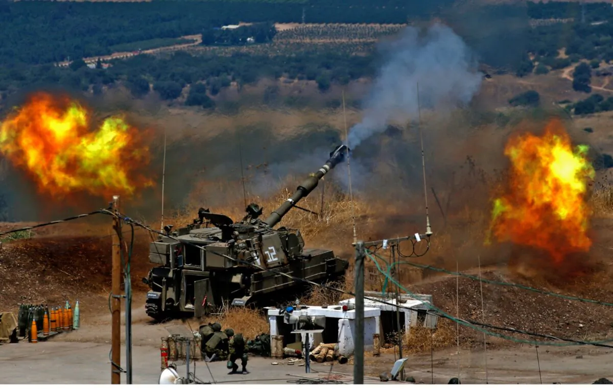 Israeli self-propelled howitzers fire towards Lebanon from a position near the northern Israeli town of Kiryat Shmona following rocket fire from the Lebanese side of the border, on Aug. 6, 2021. (Jalaa Marey/AFP via Getty Images)