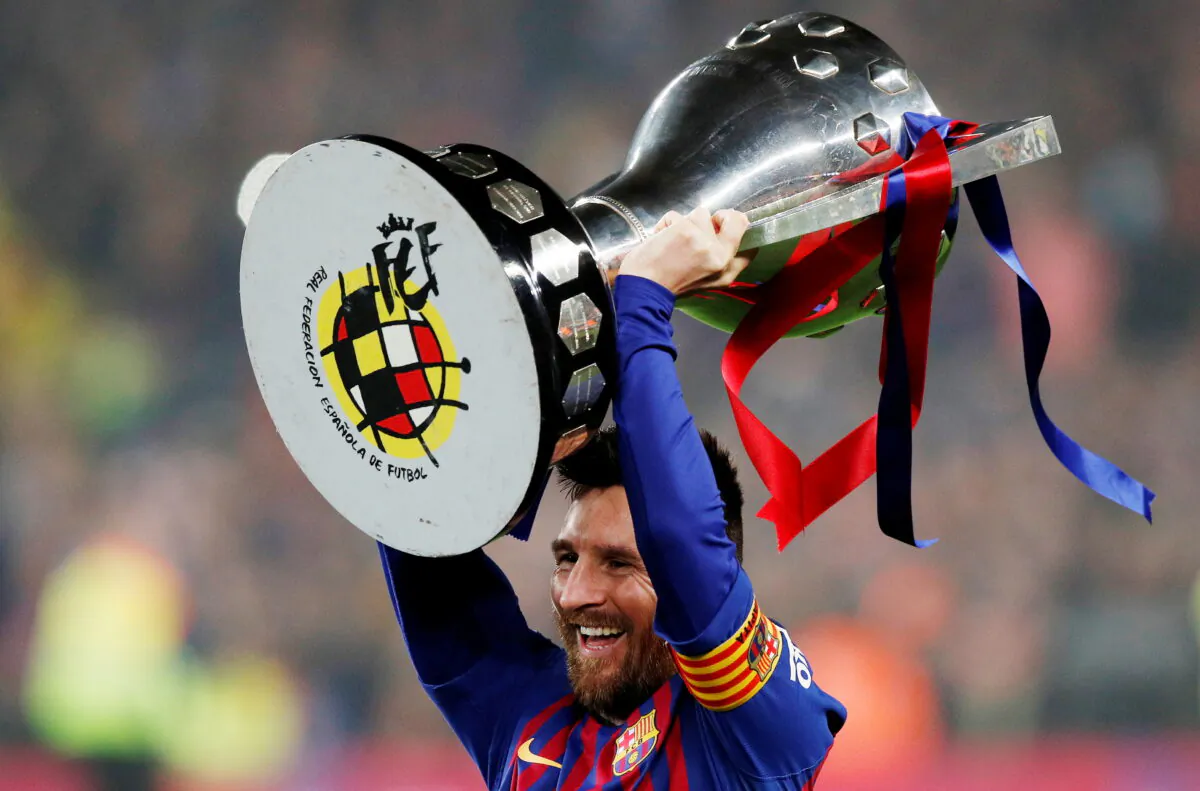 Barcelona's Lionel Messi celebrates winning La Liga with the trophy at Camp Nou, in Barcelona, Spain on April 27, 2019. (Albert Gea/Reuters)