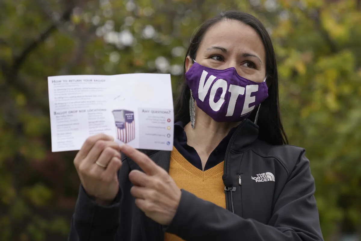 Rep. Sharice Davids (D-Kan.) talks to the media after depositing her advance ballot in Mission, Kan., on Oct. 20, 2020. (Charlie Riedel/AP Photo)
