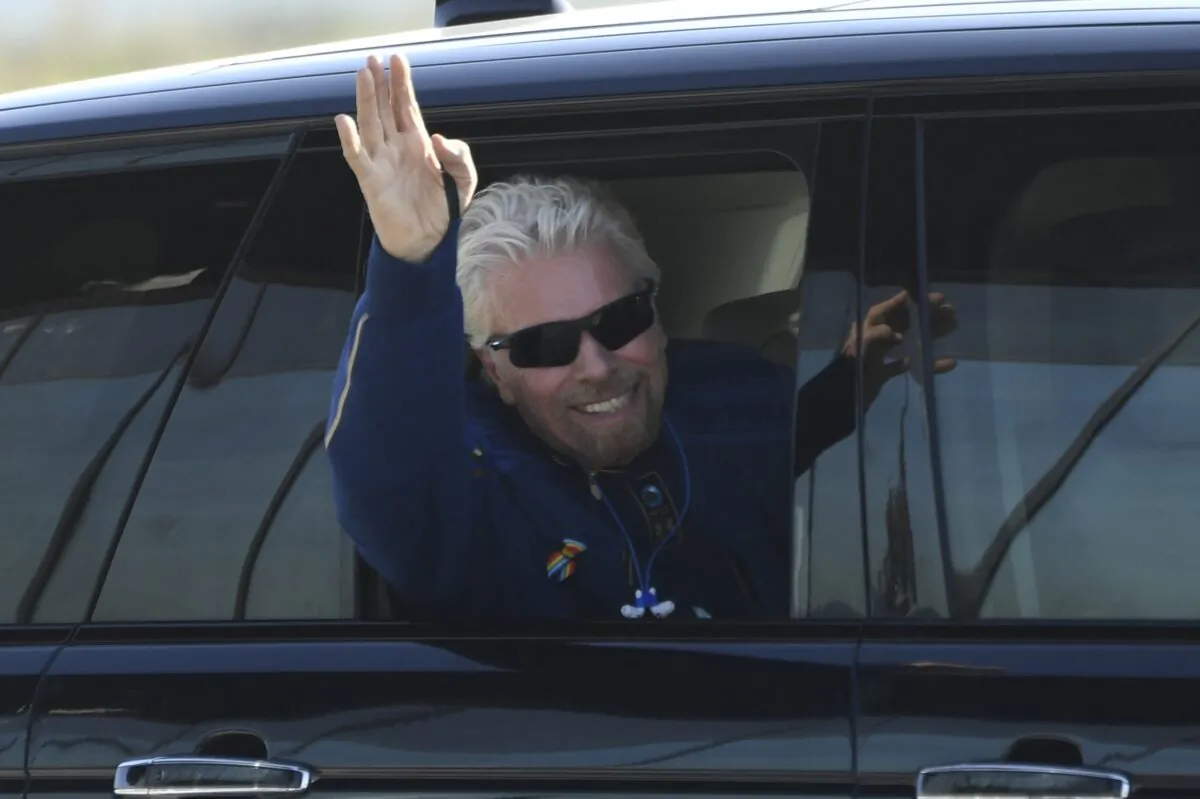 British billionaire Richard Branson is welcomed as he arrives at Spaceport America near Truth or Consequences, New Mexico, hours before travel to the cosmos aboard a Virgin Galactic space vessel, on July 11, 2021. (Patrick T. Fallon/AFP via Getty Images)