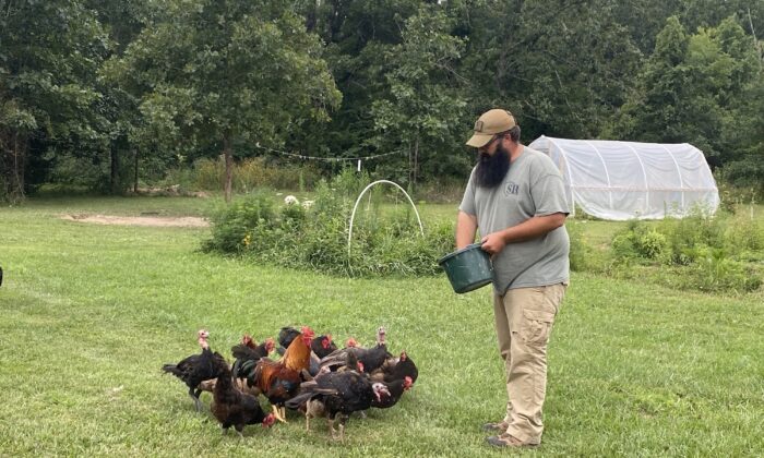 Travis Maddox, a prepper and producer of The Prepared Homestead on YouTube, feeds his turkeys and chickens. (Courtesy Travis Maddox)