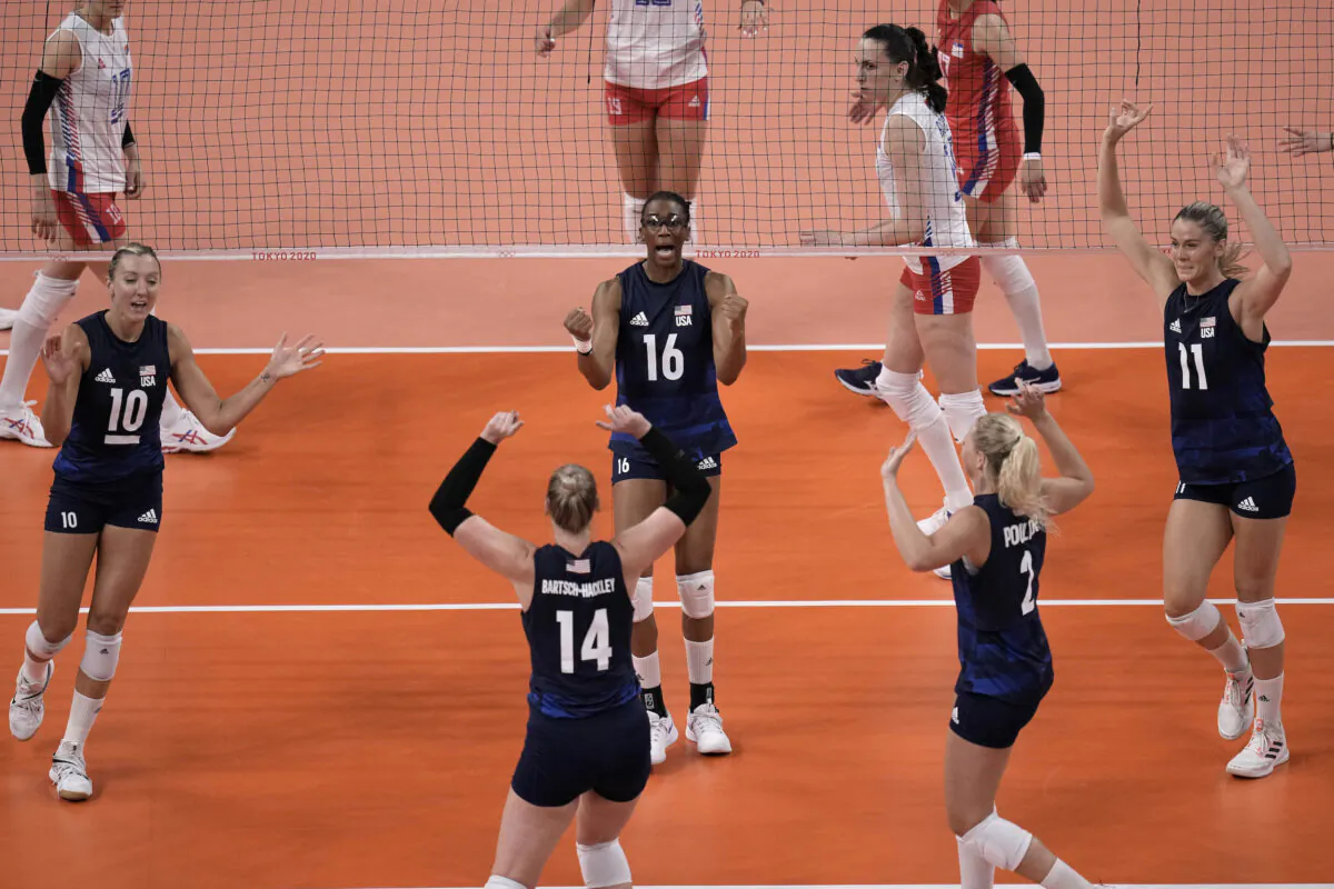 U.S. players celebrate winning a point during the women's volleyball semifinal match between Serbia and the United States at the 2020 Summer Olympics, in Tokyo, Japan, on Aug. 6, 2021. (Manu Fernandez/AP Photo)
