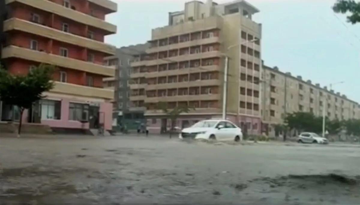 In this image taken from undated North Korean state broadcaster video, vehicles pass through flooded streets after heavy rains across South Hamgyong Province, North Korea. (KRT via APTV)