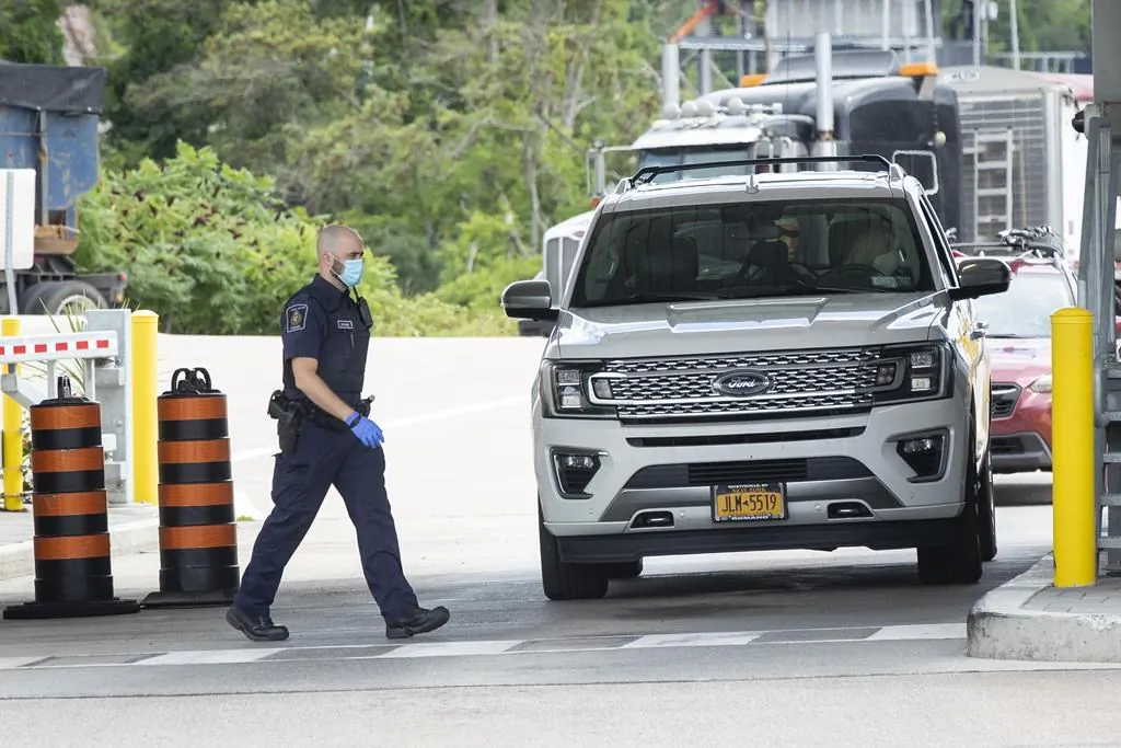 A Canada Border Services Agency agent at the Thousand Islands U.S./Canada border crossing in Lansdowne, Ont., on July 30, 2021. (The Canadian Press/Lars Hagberg)