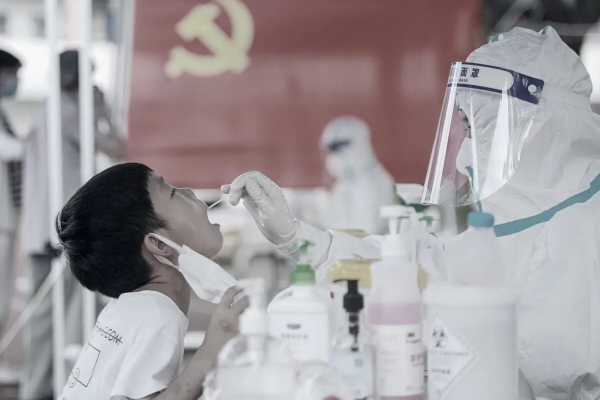 A child receives a nucleic acid test for the COVID-19 coronavirus, also known as CCP virus, in Yangzhou, in China's eastern Jiangsu province on August 5, 2021. (STR/AFP via Getty Images)
