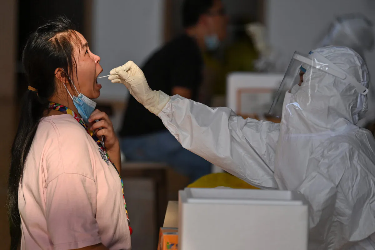 A gym employee is being tested for the COVID-19 in Wuhan, central China's Hubei Province on Aug. 5, 2021. (STR/AFP via Getty Images)