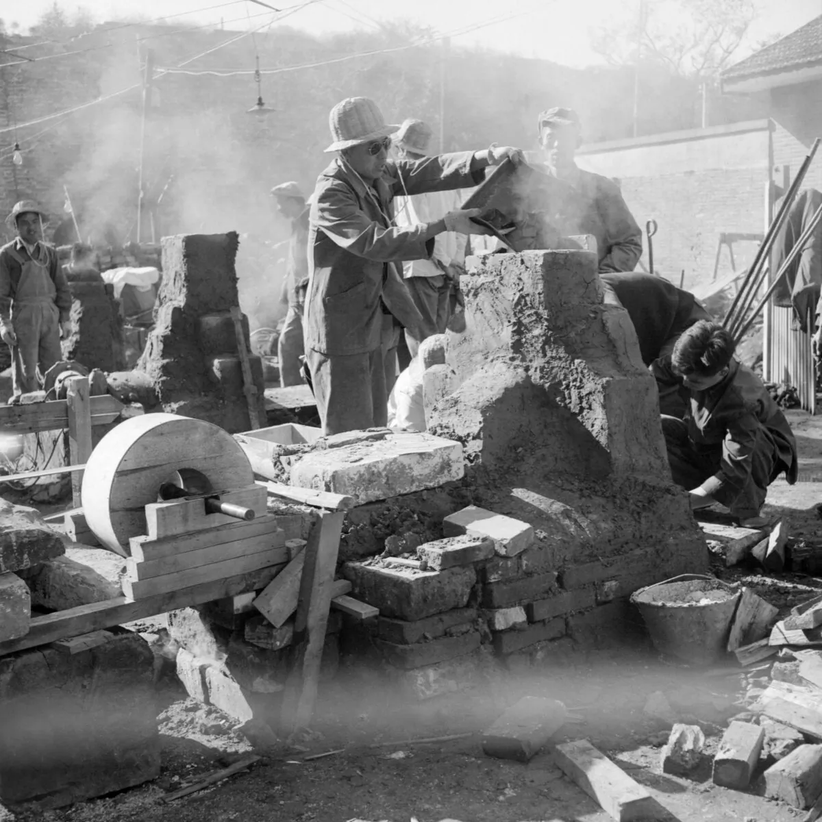 Employees of the Shin Chiao Hotel build in the hotel courtyard (background) a small and rudimentary smelting steel furnace during the "Great Leap Forward," a period intended to help China to catch up to Great Britain's economy within 15 years, in Beijing in October 1958. The ensuing famine cost China some 40 million lives. (Jacquet Francillon/AFP via Getty Images)