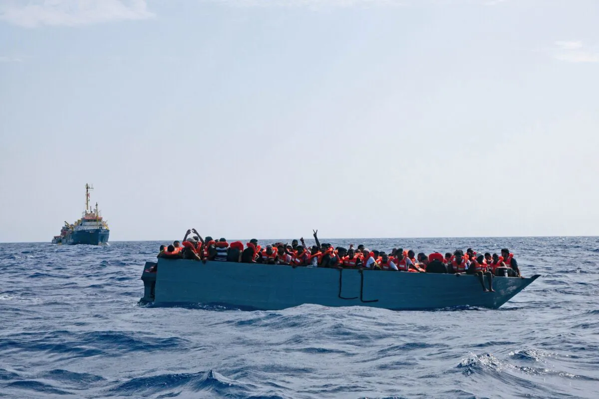 An overcrowded boat waits to be rescued by Sea Watch 3 in the Mediterranean Sea on Aug. 2, 2021. (Sea-Watch.org via AP)