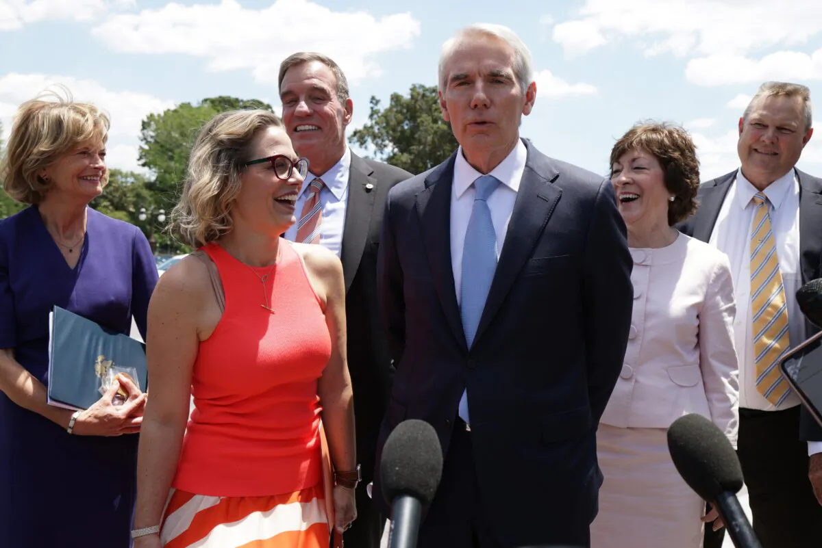 (L-R) Sen. Lisa Murkowski (R-Alaska), Sen. Kyrsten Sinema (D-Ariz.), Sen. Mark Warner (D-Va.), Sen. Rob Portman (R-Ohio), Sen. Susan Collins (R-Maine), and Sen. Jon Tester (D-Mon.) speak to members of the press as they arrive at the U.S. Capitol after a meeting with President Joe Biden at the White House in Washington, on June 24, 2021. (Alex Wong/Getty Images)