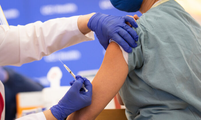 UCI medical staff receives a COVID-19 vaccination in Orange, Calif., on Dec. 16, 2020. (John Fredricks/The Epoch Times)