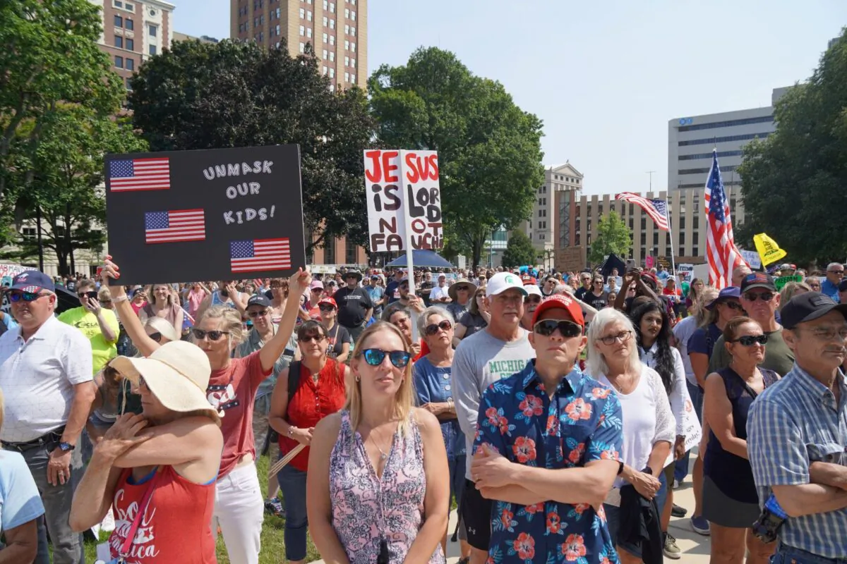 A view of part of the crowd protesting against mandatory vaccinations and mask mandates at a rally at the State Capitol grounds in Lansing, Mich., on Aug. 6, 2021. (Steven Kovac/Epoch Times)