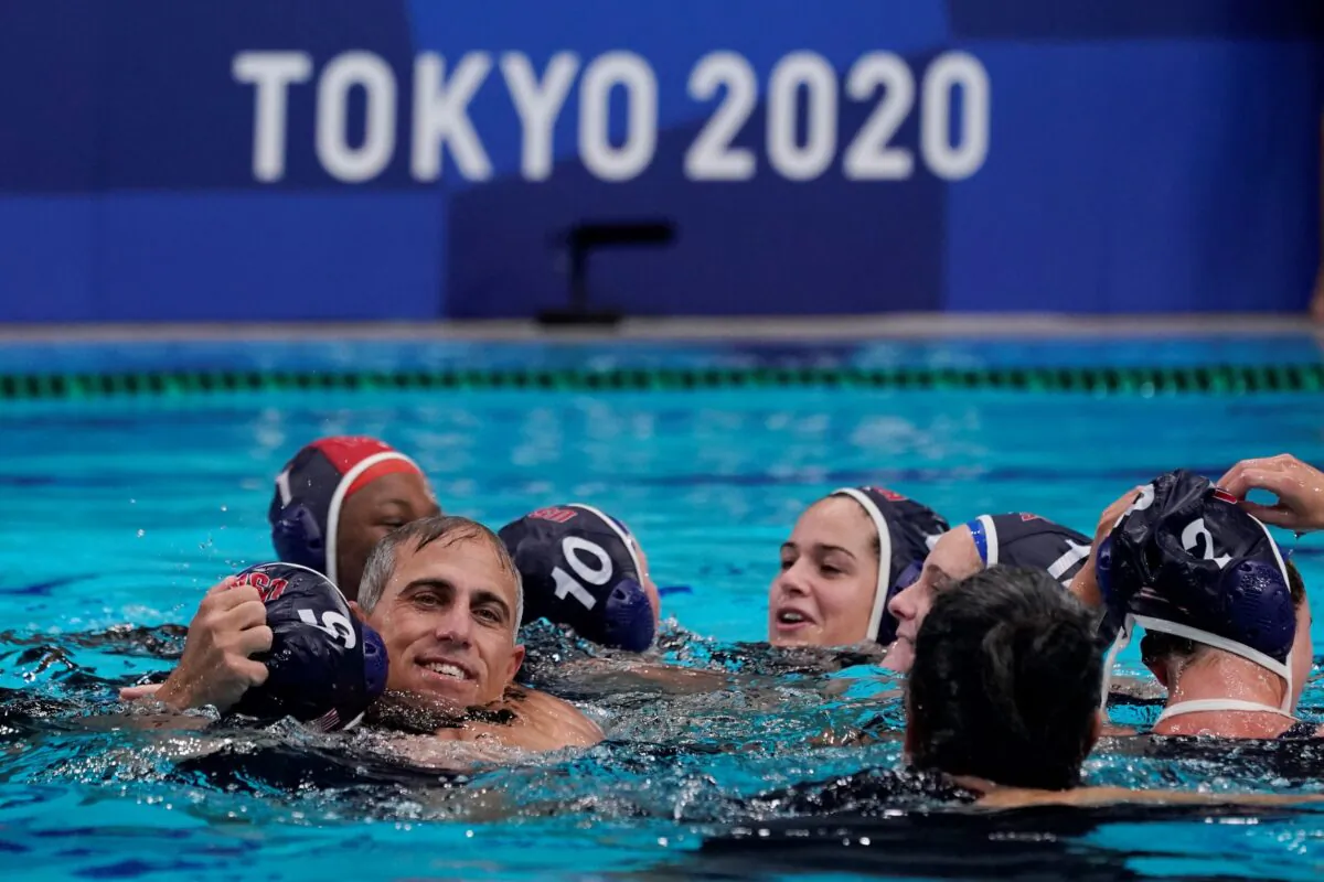 United States head coach Adam Krikorian hugs Paige Hauschild (5) after defeating Spain in the women's water polo gold medal match at the 2020 Summer Olympics, in Tokyo, Japan, on Aug. 7, 2021. (Mark Humphrey/AP Photo)