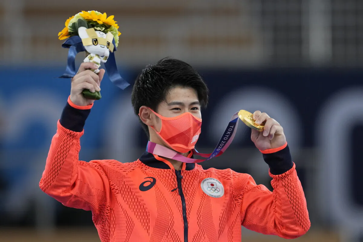 Daiki Hashimoto of Japan poses with his gold medal for the artistic gymnastics men's all-around final at the 2020 Summer Olympics, in Tokyo, on July 28, 2021. (Natacha Pisarenko/AP Photo)