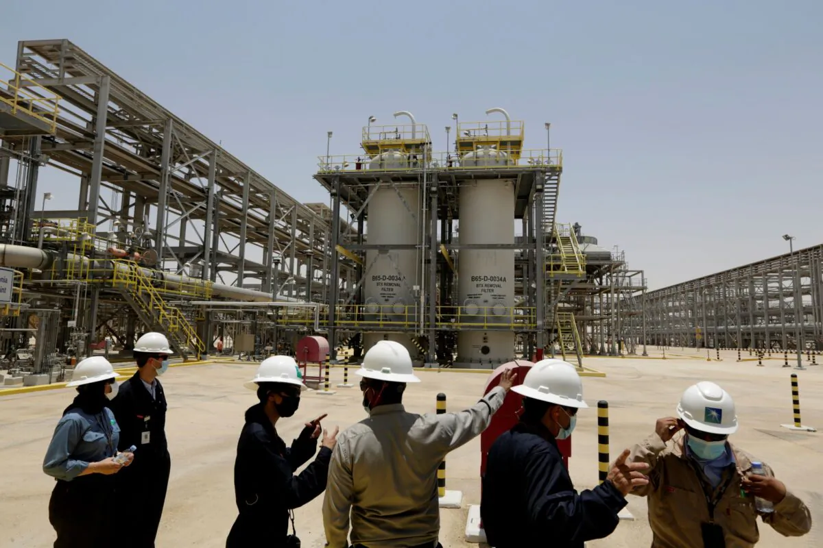 Saudi Aramco engineers and journalists look at the Hawiyah Natural Gas Liquids Recovery Plant in Hawiyah, in the Eastern Province of Saudi Arabia on June 28, 2021. (Amr Nabil/AP Photo)