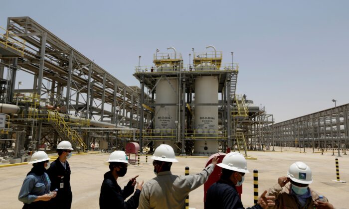 Saudi Aramco engineers and journalists look at the Hawiyah Natural Gas Liquids Recovery Plant in Hawiyah, in the Eastern Province of Saudi Arabia on June 28, 2021. (Amr Nabil/AP Photo)