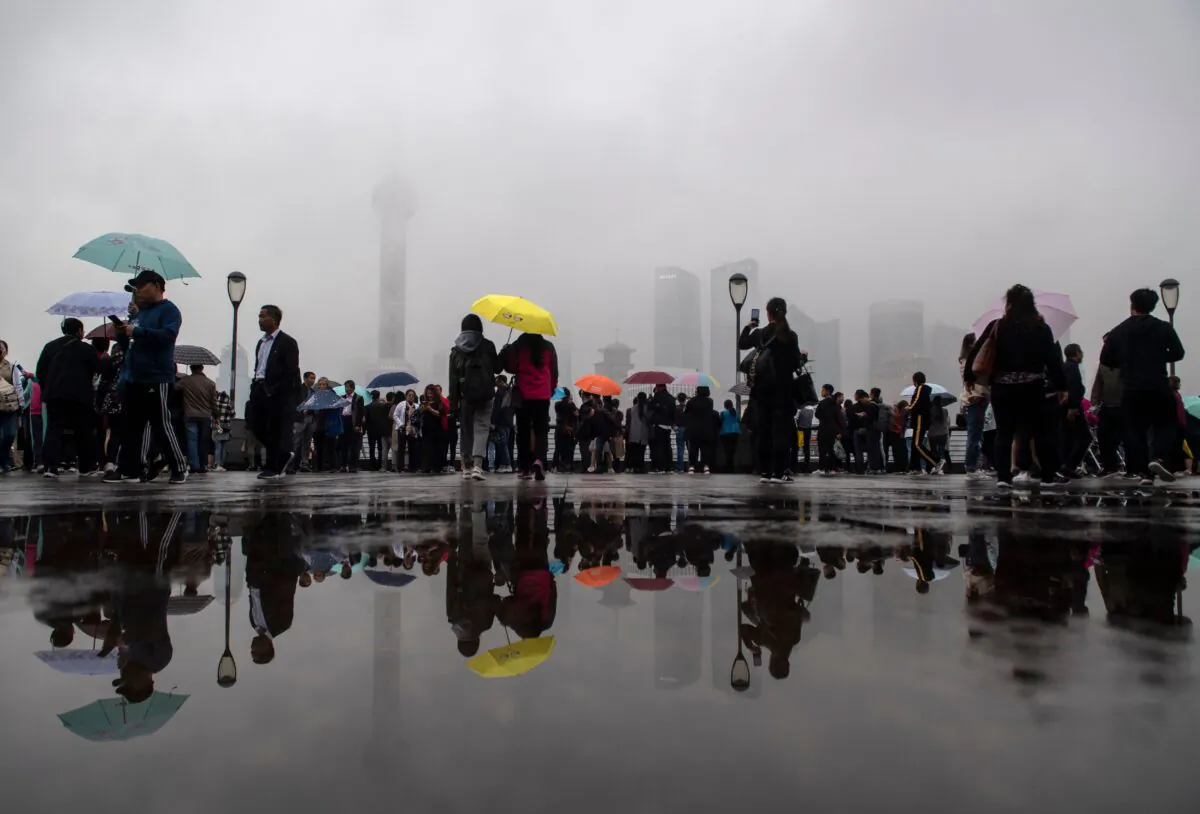 Tourists look at the Shanghai skyline from the Lujiazui Financial District of Pudong, China, on Oct. 22, 2018. (Johannes Eisele/AFP via Getty Images)