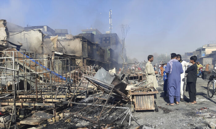 Afghans inspect damaged shops after fighting between Taliban and Afghan security forces in Kunduz city, northern Afghanistan, on Aug. 8, 2021. (Abdullah Sahil/AP Photo)