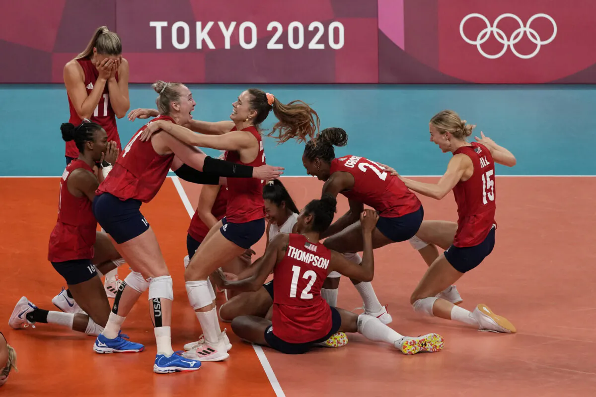 Players from the United States react after defeating Brazil to win the gold medal in women's volleyball at the 2020 Summer Olympics, in Tokyo, Japan, on Aug. 8, 2021. (Frank Augstein/AP Photo)