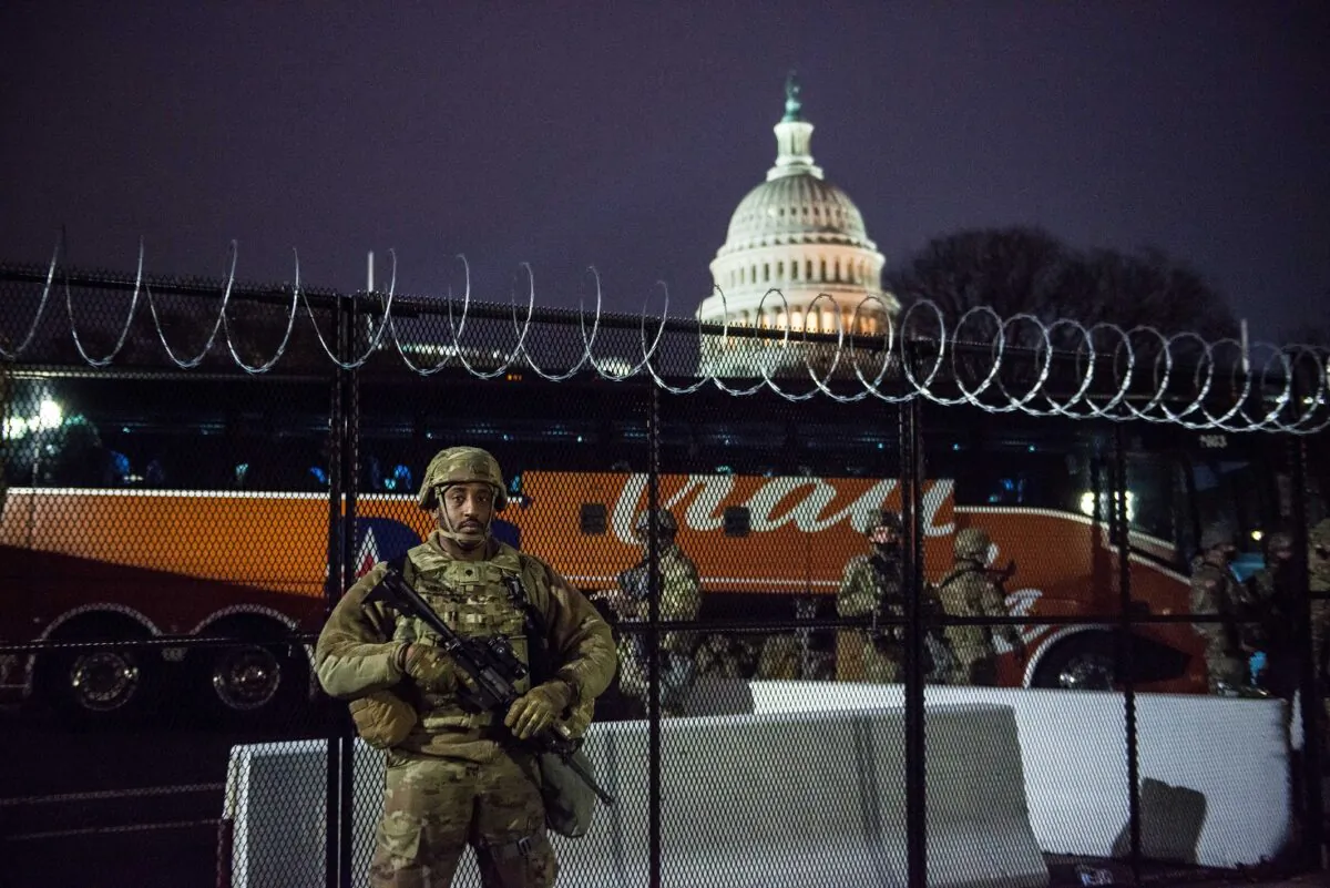 A National Guardsman stands outside the razor wire fencing that surrounds the U.S. Capitol in Washington on Jan. 15, 2021. (Liz Lynch/Getty Images)