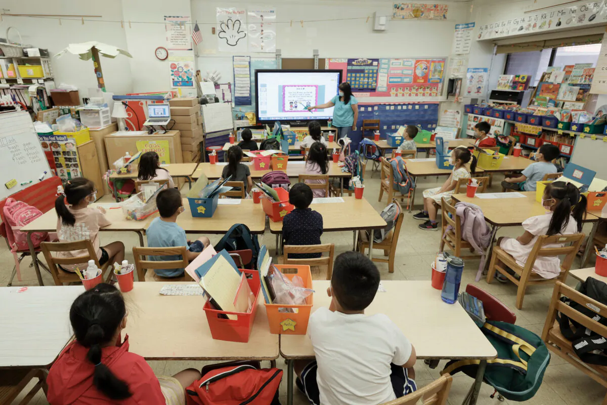 Melissa Moy, a teacher at Yung Wing School P.S. 124, goes over a lesson on a monitor during the in-person summer program for students in New York City, on July 22, 2021. (Michael Loccisano/Getty Images)