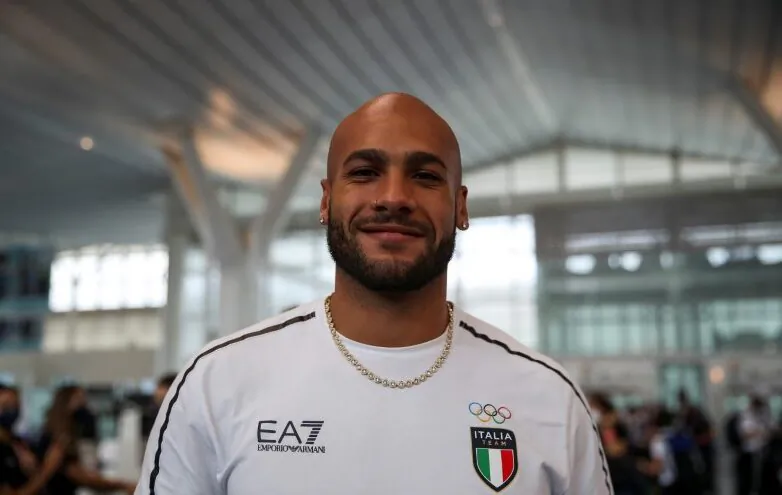 Italy's 100 metres Olympic champion Lamont Marcell Jacobs poses for a picture as he returns home to Rome at Haneda Airport in Tokyo, Japan, on Aug. 9, 2021. (Yara Nardi/Reuters)