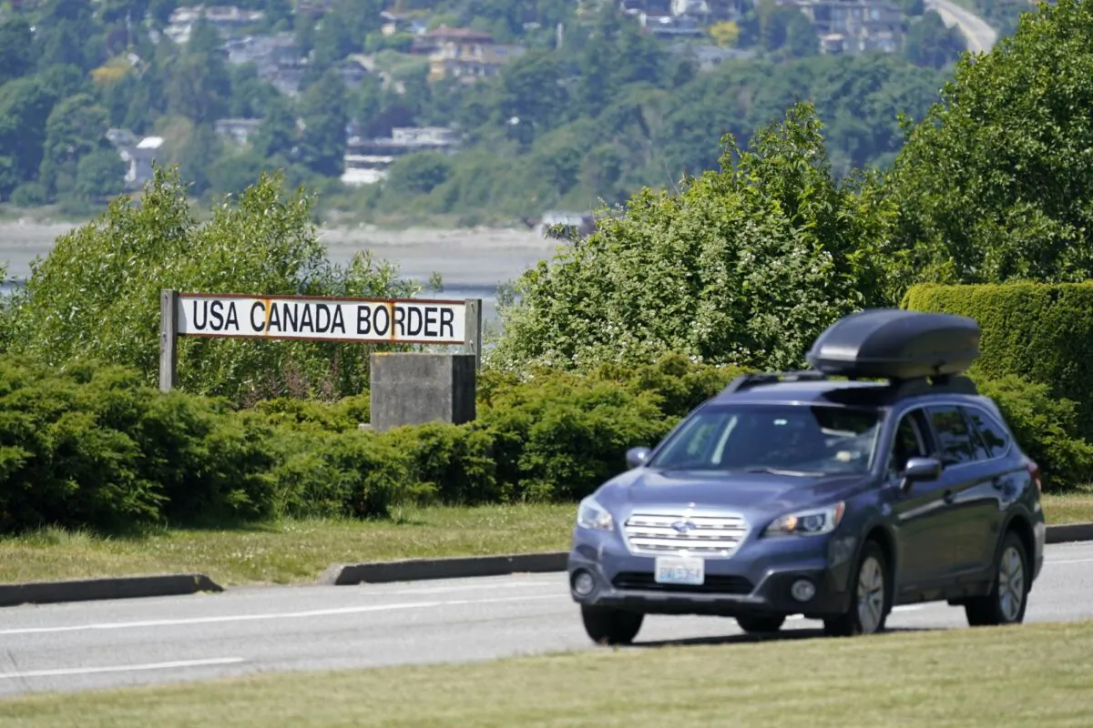 A car heads into the U.S. from Canada at the Peace Arch border crossing in Blaine, Wash., on June 8, 2021. (Elaine Thompson/AP Photo)