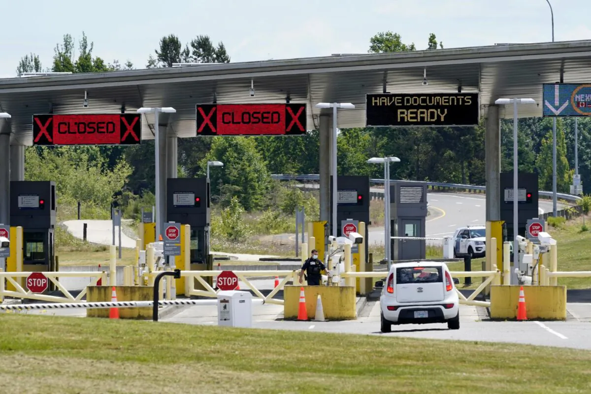 A car approaches one of the few lanes open at the Peace Arch border crossing into the U.S. in Blaine, Wash., on June 8, 2021. (Elaine Thompson/AP Photo)