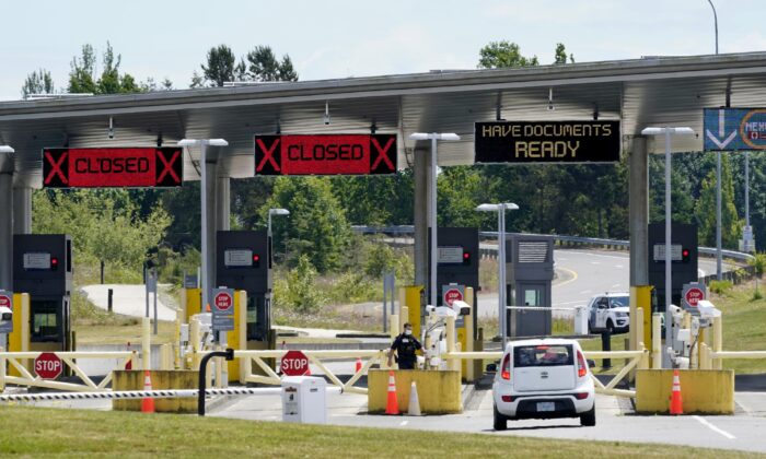 A car approaches one of the few lanes open at the Peace Arch border crossing into the U.S. in Blaine, Wash., on June 8, 2021. (Elaine Thompson/AP Photo)