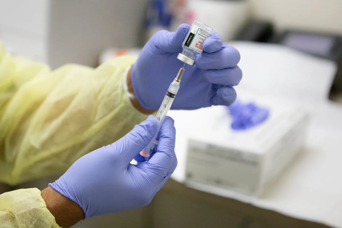 A medical volunteer prepares the Moderna coronavirus vaccination for a patient at Lestonnac Free Clinic in Orange, Calif., on March 9, 2021. (John Fredricks/The Epoch Times)