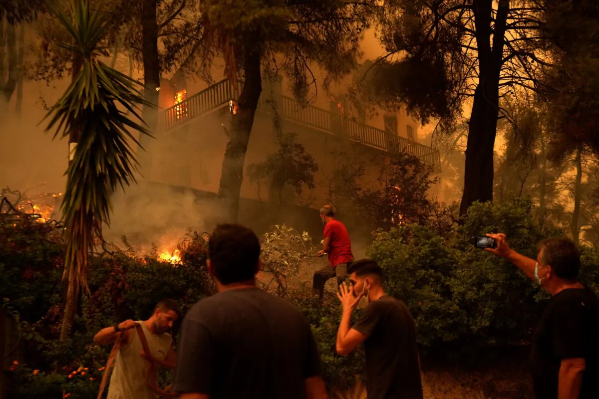 Flames burn a house at Pefki village on Evia island, about 118 miles north of Athens, Greece, on Aug. 8, 2021. (Petros Karadjias/AP Photo)