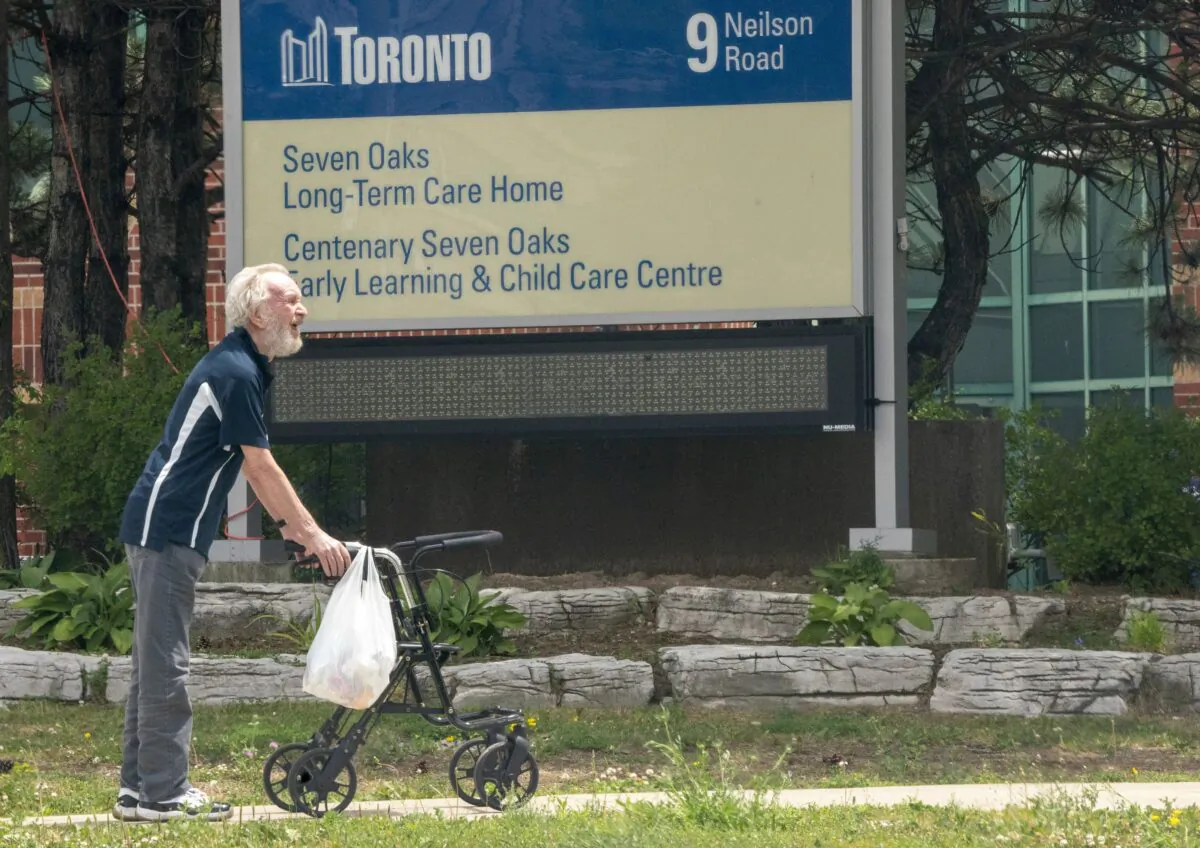 A resident takes a walk outside the Seven Oaks Long-Term Care Home in Toronto on June 25, 2020. (The Canadian Press/Frank Gunn)