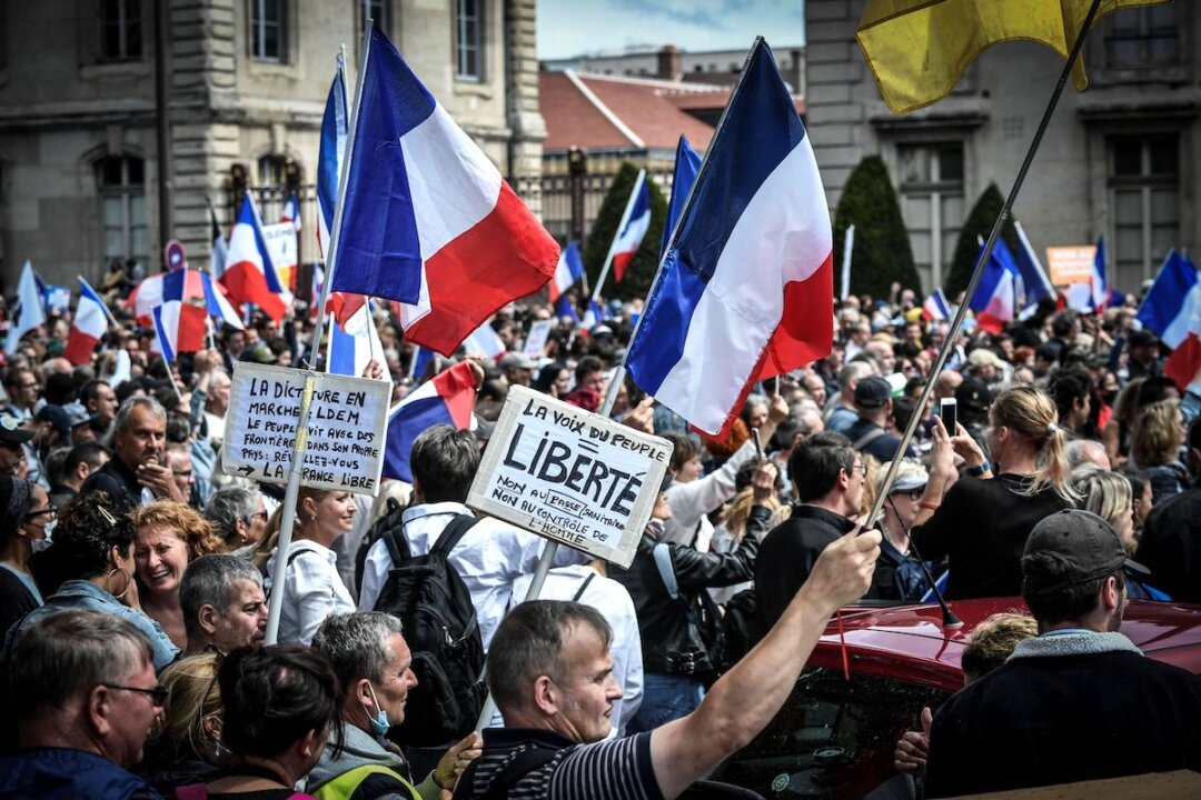 Protestors during a demonstration against a mandatory COVID-19 health pass to access most of public spaces, near Ecole Militaire in Paris, France on Aug. 7, 2021. (Stephane De Sakutin/AFP)