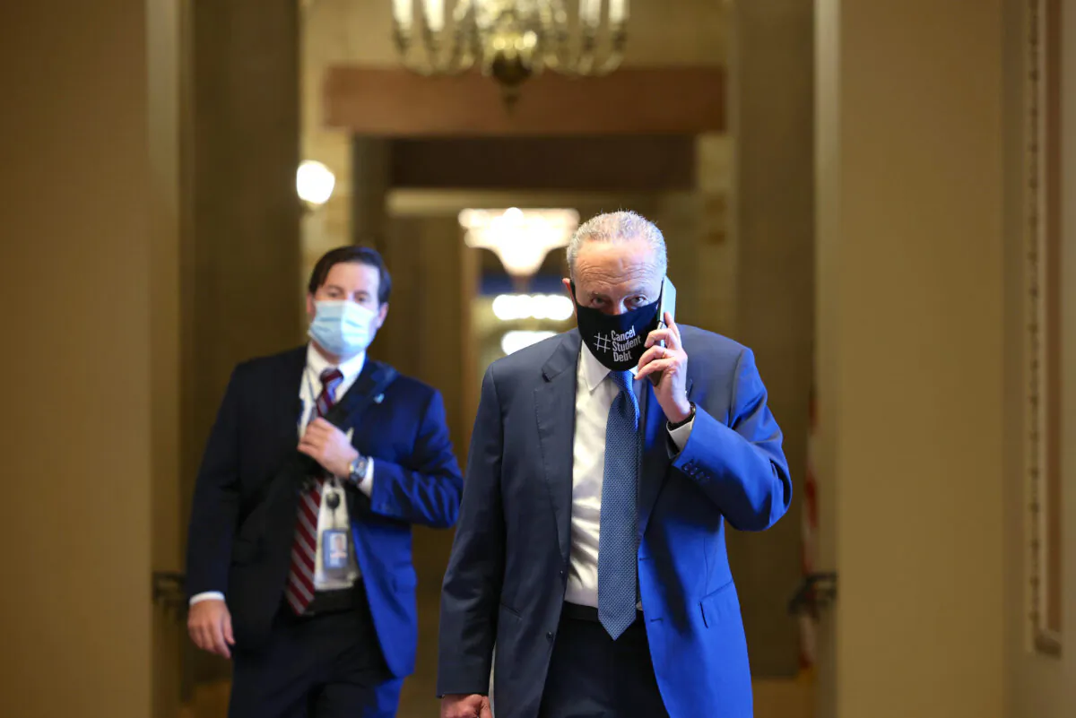 Senate Majority Leader Chuck Schumer (D-NY) speaks on the phone as he walks back to his office in the U.S. Capitol building on Aug. 5, 2021. (Anna Moneymaker/Getty Images)