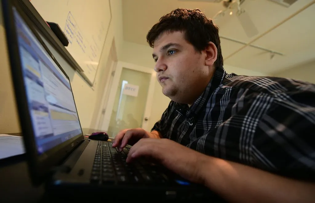 A man sits at a computer in Santa Monica, Calif., on Aug. 24, 2016. (Frederic J. Brown/AFP via Getty Images/File photo)