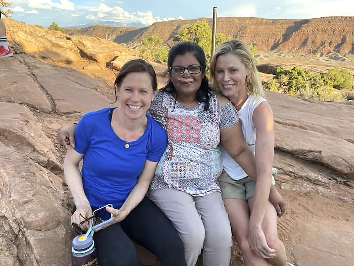 Minnie John (C) poses with actress Julie Bowen (R) and Bowen's sister, Dr. Annie Luetkemeyer (L) in Arches National Park, Utah, on Aug. 3, 2021. (Shaji John via AP)