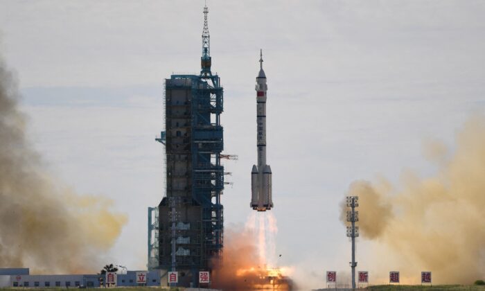 A Long March-2F carrier rocket, carrying the Shenzhou-12 spacecraft and a crew of three astronauts, lifts off from the Jiuquan Satellite Launch Centre in the Gobi desert in China on June 17, 2021, the first crewed mission to China's new space station. (Greg Baker/AFP via Getty Images)