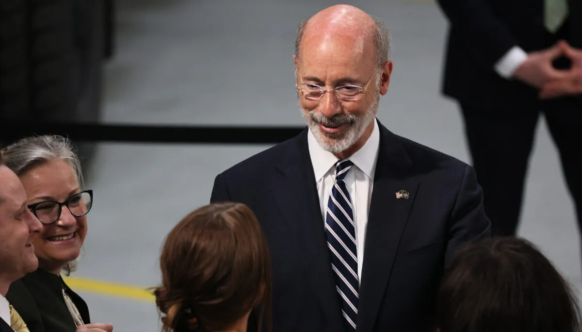 Pennsylvania Gov. Tom Wolf greets people as he awaits a speech from U.S. President Joe Biden at Mack Truck Lehigh Valley Operations in Macungie, Pennsylvania, on July 28, 2021. (Michael M. Santiago/Getty Images)