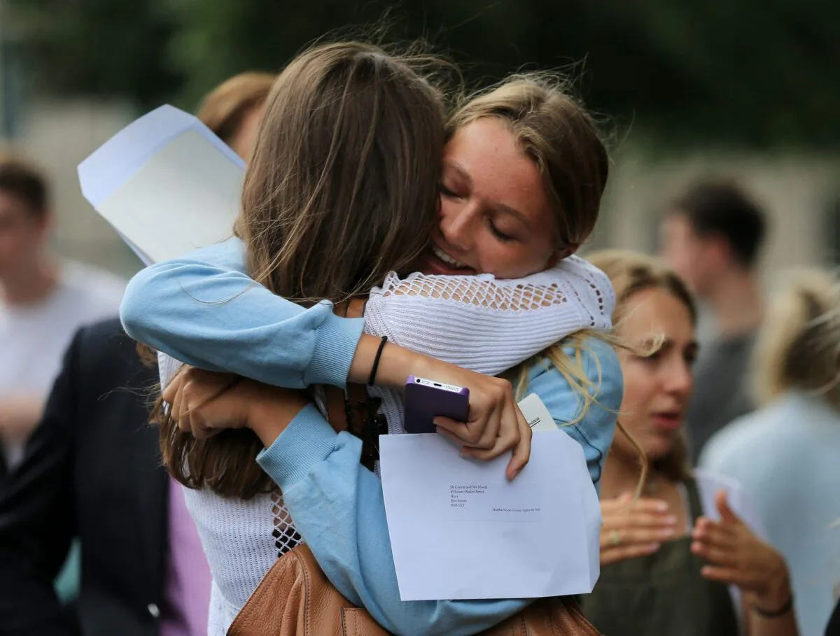 Students celebrate their A-level results in a file photo. (Gareth Fuller/PA)
