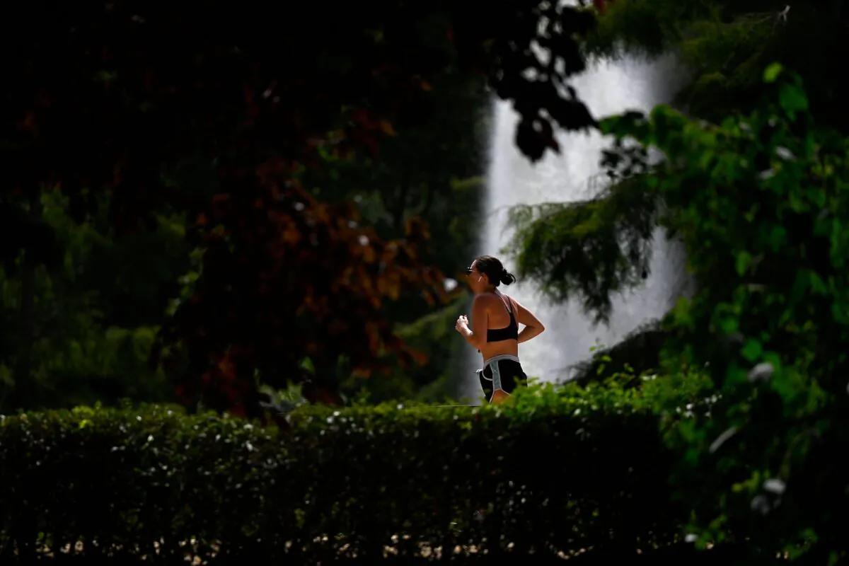 A woman jogs at the Retiro park in Madrid, on Aug. 11, 2021. (Pierre-Philippe Marcou/AFP via Getty Images)