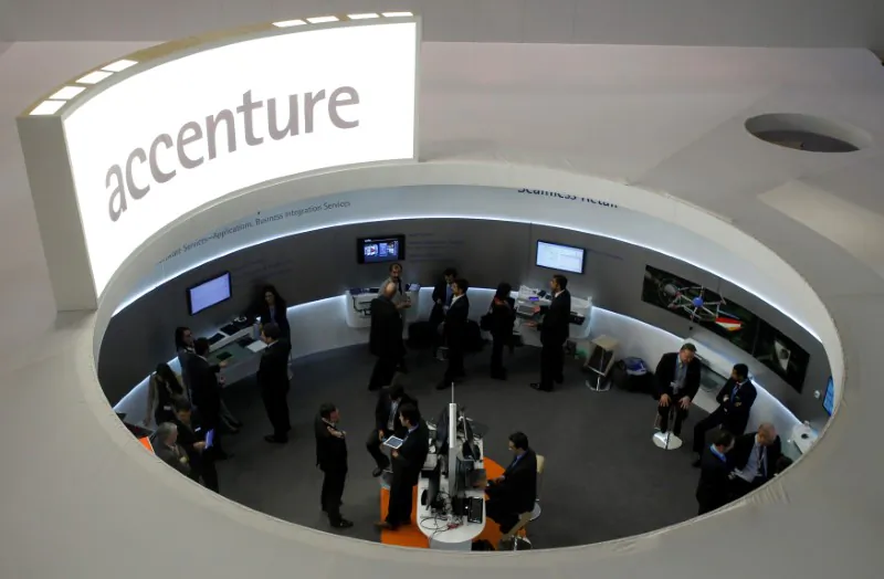 Visitors look at devices at Accenture stand at the Mobile World Congress in Barcelona, Spain, on Feb. 26, 2013. (Albert Gea/Reuters)