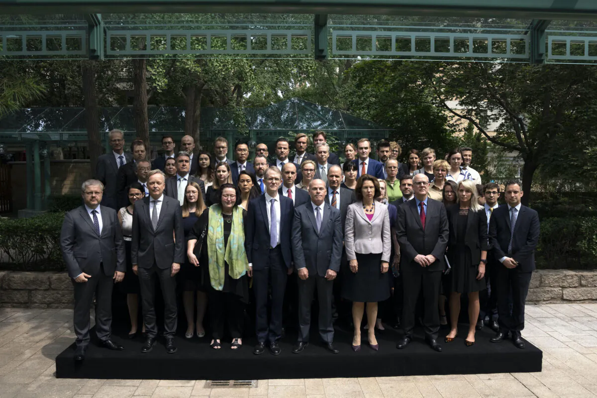 Diplomatic representatives from Canada and more than two dozen other countries pose for a group photo at an event held in connection with the announcement of the sentence for Canadian citizen Michael Spavor, at the Canadian Embassy in Beijing on Aug. 11, 2021. (AP Photo/Mark Schiefelbein)