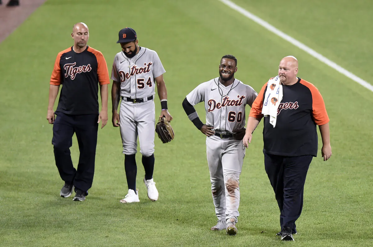 Derek Hill #54 and Akil Baddoo #60 of the Detroit Tigers come out of the game after colliding with each other in the eighth inning against the Baltimore Orioles at Oriole Park at Camden Yards in Baltimore, Md., on Aug. 10, 2021. (Greg Fiume/Getty Images)