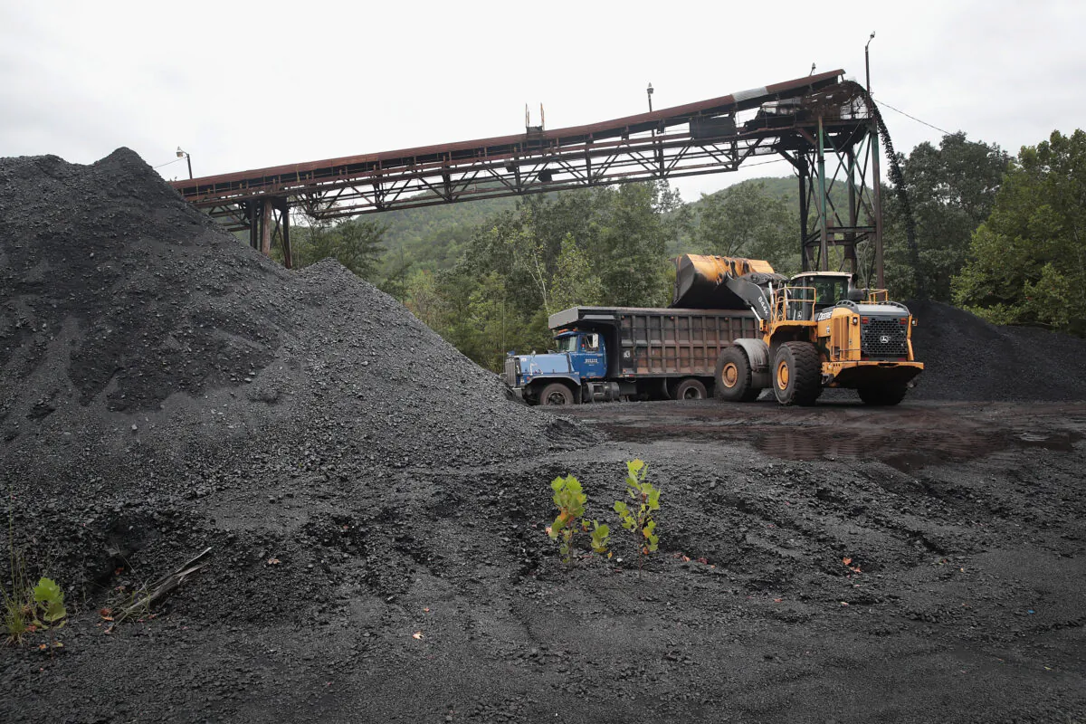 A truck is loaded with coal at a mine near Cumberland, Ky., on Aug. 26, 2019. Eastern Kentucky, once littered with coal mines, is seeing that lifeblood rapidly slip away. (Scott Olson/Getty Images)