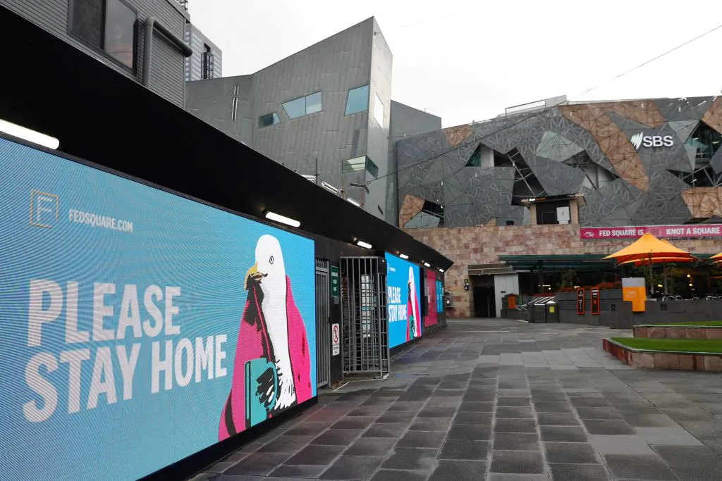 Signage for people to stay home is seen at Federation Square in downtown Melbourne, Australia, on Aug. 6, 2021, (Con Chronis/AFP via Getty Images)