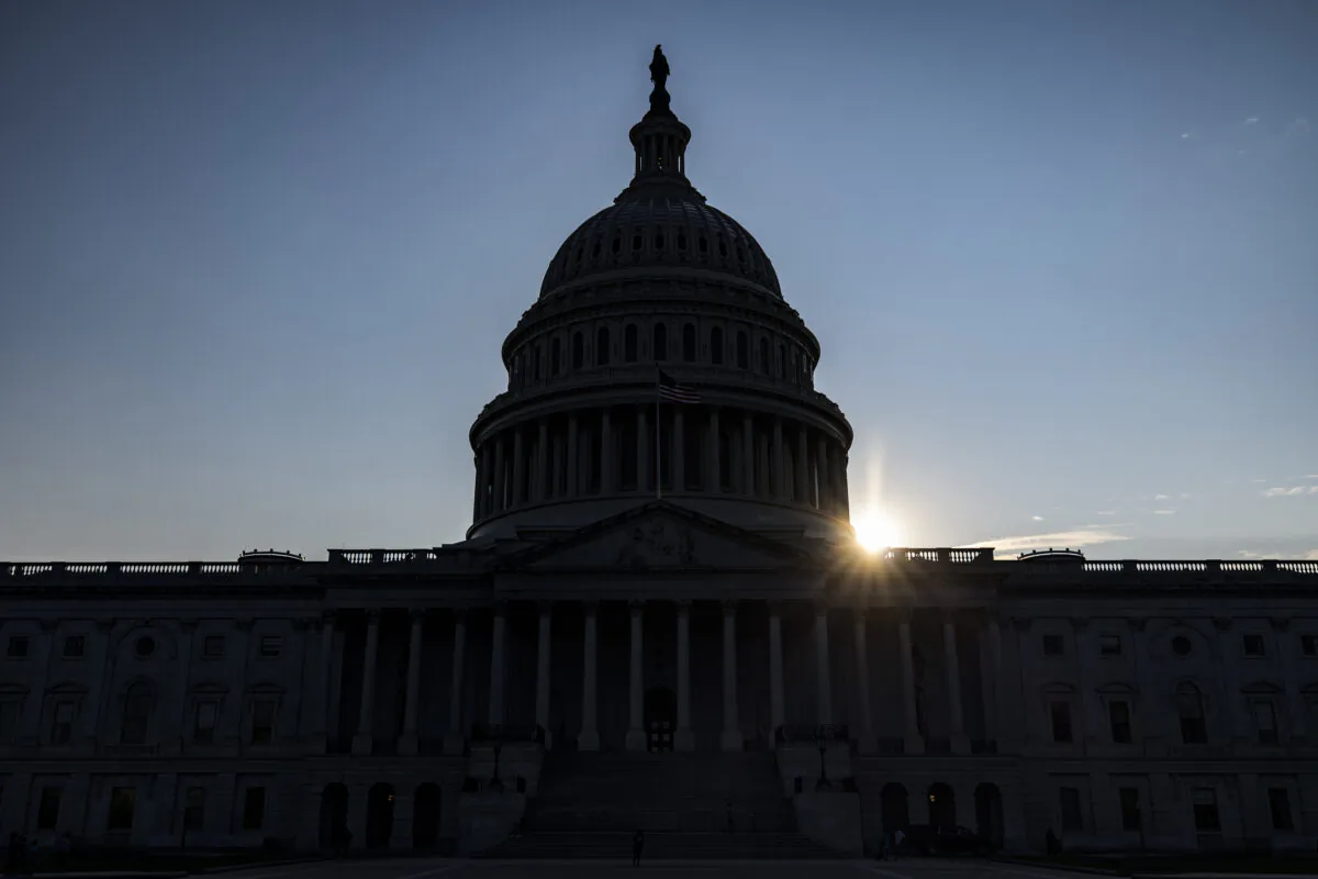 The sun begins to set behind the U.S. Capitol Building in Washington on Aug. 8, 2021. (Samuel Corum/Getty Images)
