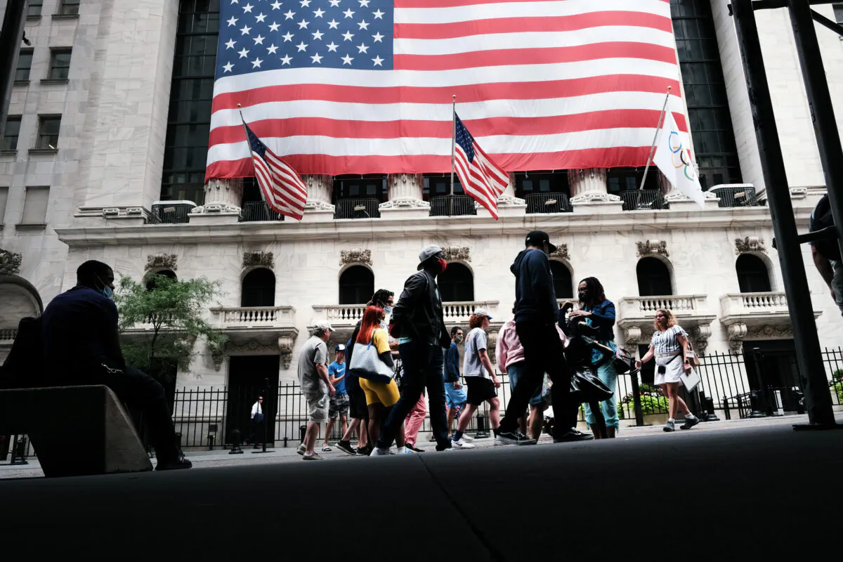 People walk by the New York Stock Exchange (NYSE) in New York City on Aug. 10, 2021. (Spencer Platt/Getty Images)