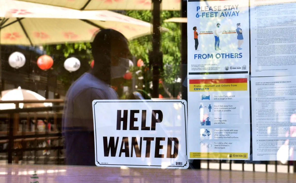 A 'Help Wanted' sign is posted beside coronavirus safety guidelines in front of a restaurant in Los Angeles on May 28, 2021. (Frederic J. Brown/AFP via Getty Images)